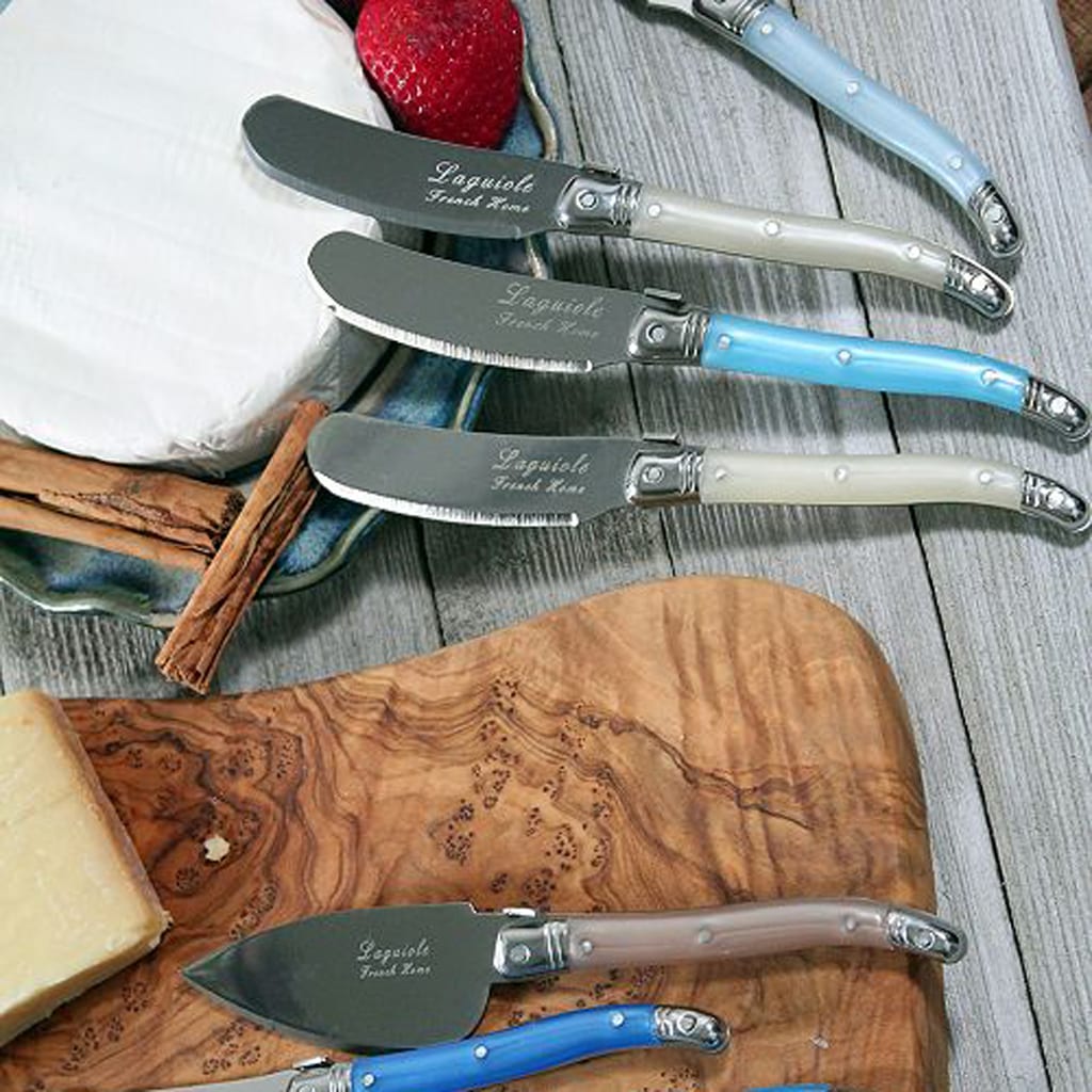 Cheese knives with engravings on blades and blue, brown or white handles