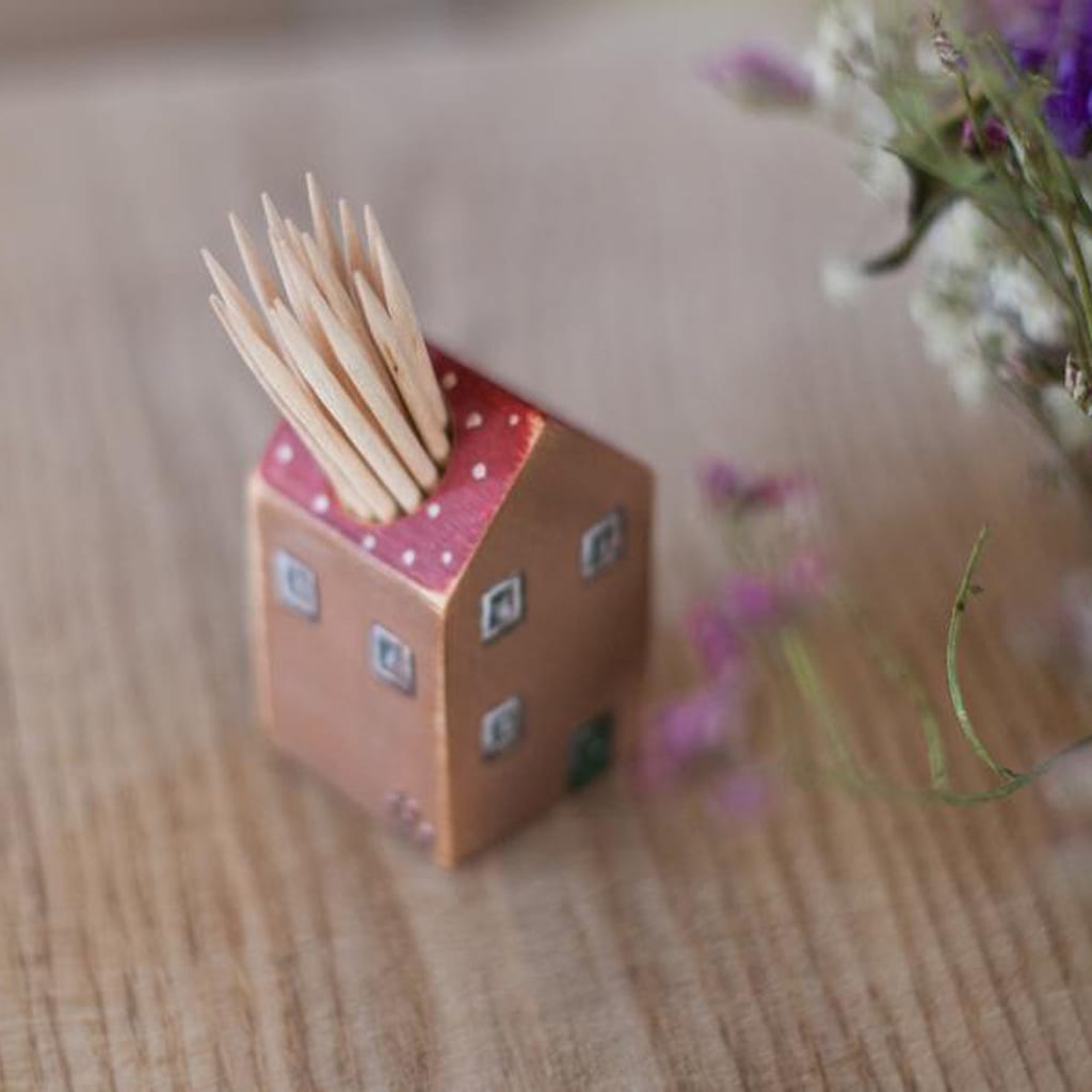 Tooth pick holder shaped like a house with red roof